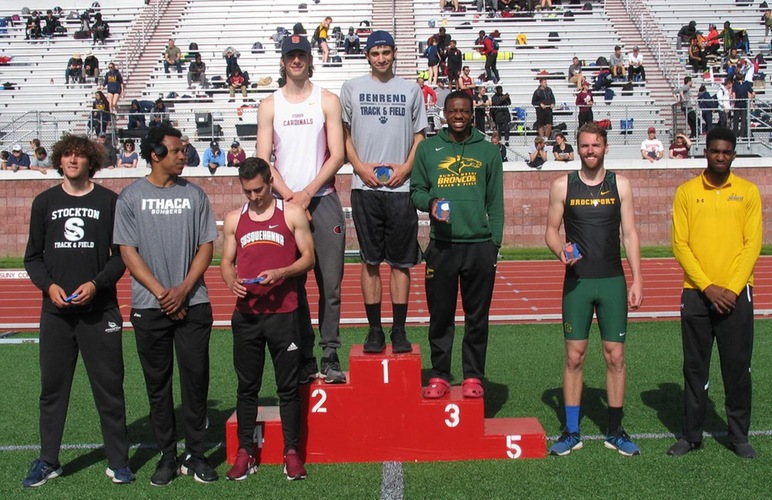 Glenn Butler standing in third place on the podium for earning bronze in the high jump.
