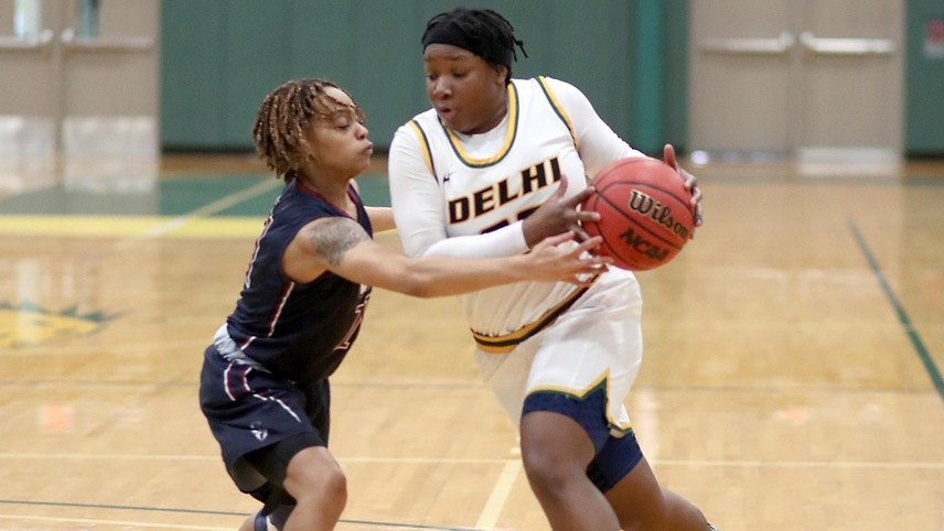 Samiaya Salley #23 attempts to dribble the ball past a defender on her way to the hoop.