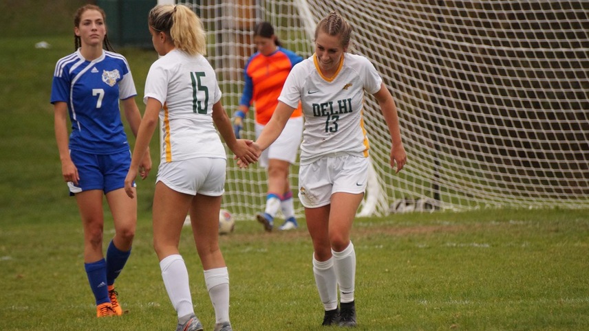 Brianna Laing celebrating with a teammate after scoring a goal.