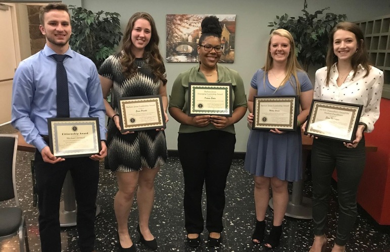 Five SUNY Delhi student-athletes standing with their awards from the Student Leadership awards ceremony.