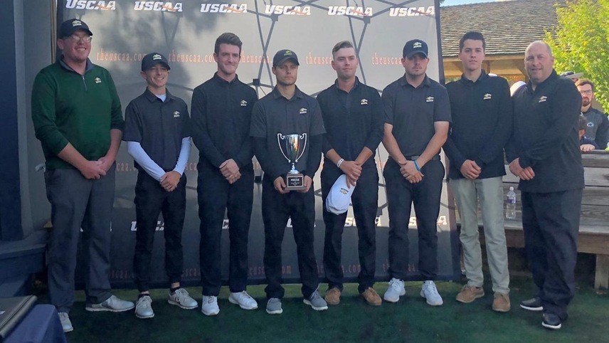 The men's golf team posing with their second place USCAA Championship trophy.