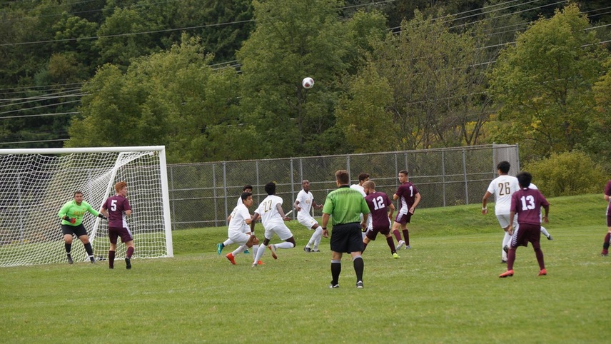 The Broncos defense looks to defend a ball following a corner kick.
