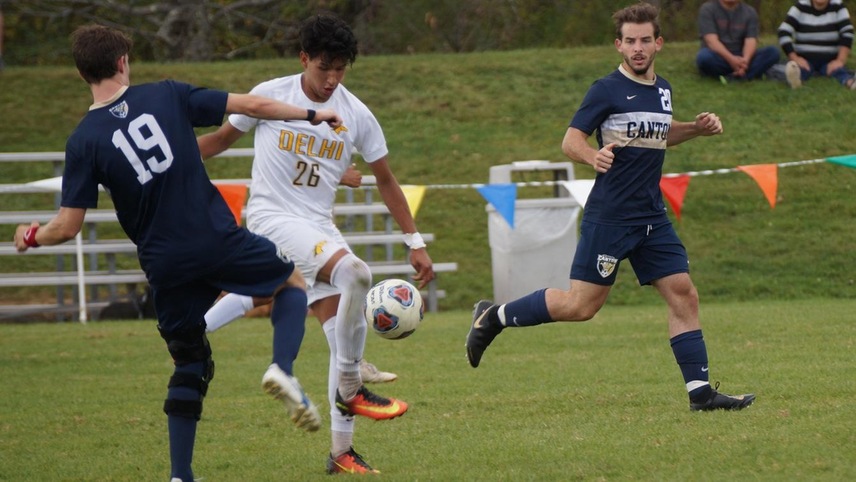 Juan Velez fighting for the ball against a SUNY Canton player.