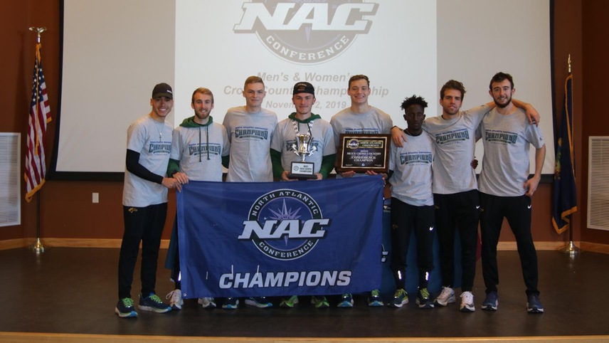 The men's cross country team in their NAC championship shirts posing with their NAC championship gear.