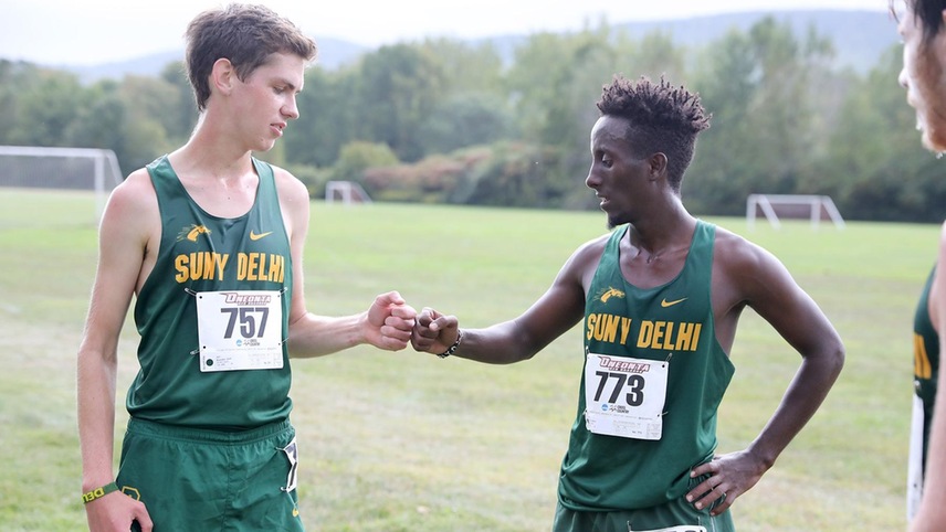 Seth Bywater and Abshir Yerow fist pumping each other before a race.