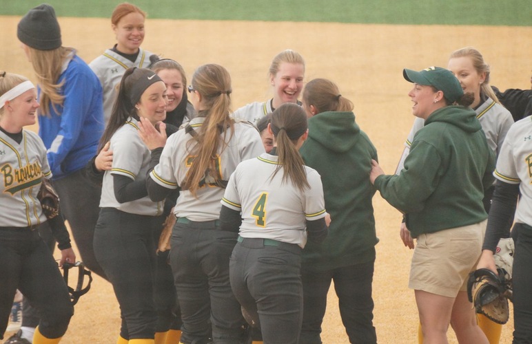The SUNY Delhi softball team celebrating after their second-game win over SUNY Poly. 