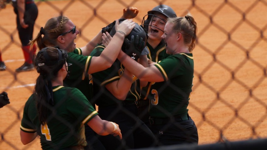 The Broncos celebrating with Sierra Keesler after she hit a home run.