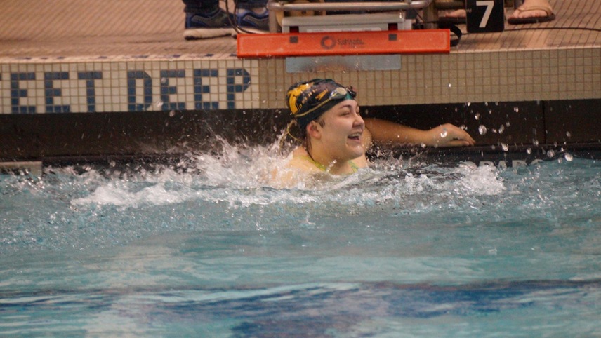 Kaitlyn Quezada celebrating after beating a school record in the 100-yard breaststroke.