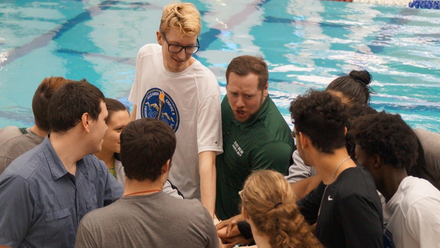 Head coach Mike Burud breaks down a team huddle prior to the conference championships. 