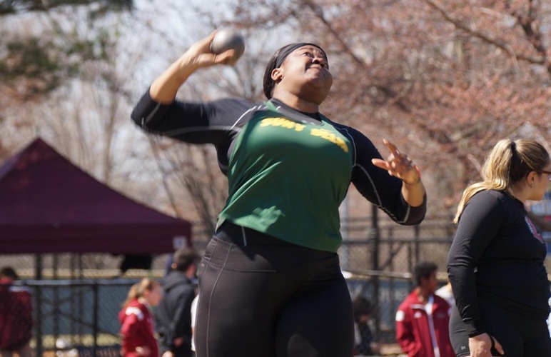 Diana Echols about to release a shot put. 