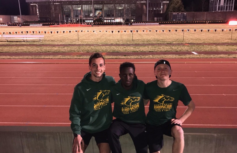 Kobie Lane, Abshir Yerow and Nick Arnecke standing in front of Princeton University's track facility. 