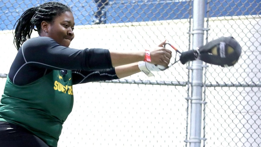 Diana Echols in mid-rotation during a weight throw. 