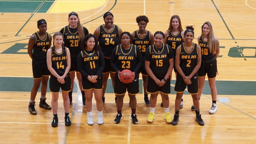 The women's basketball team poses for a team photo. 