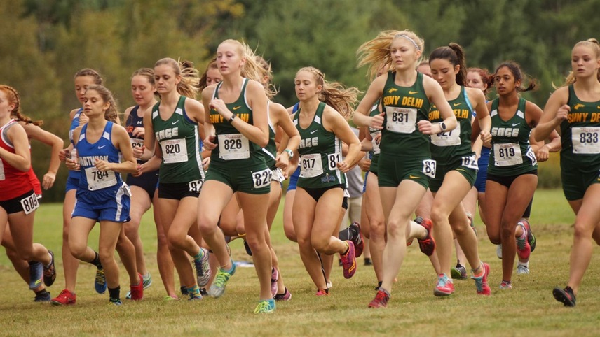The women's cross country team running out of the box.